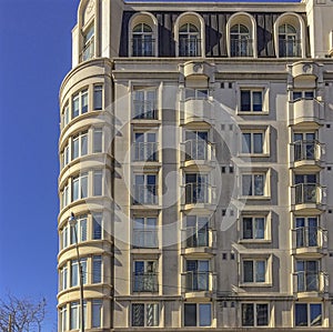 Side view on modern residential building with many sunlit balconies