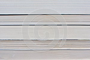 Side view of multiple old stacked books