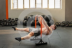 Muscular man performing straddle front lever calisthenics exercise photo