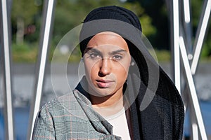 Side view of a muslim adult woman looking at camera in the park