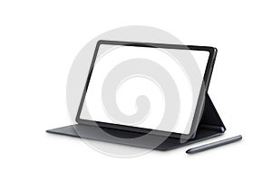 Side view of the new model 10.4` black tablet is placed on the cover with a pen, blank screen with copy space for text photo