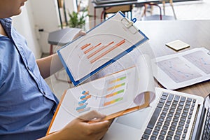 Side view of office employee reading financial reports