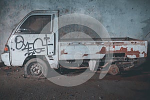 Side view of an old abandoned truck left in a garage