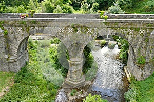 The old bridge over the Gijou river in the village of Lacaze photo