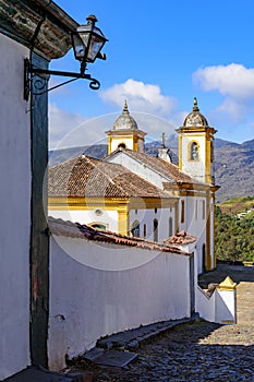 Side view of an old colorful baroque church with the mountains
