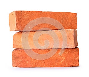 Side view of old cracked red or orange bricks in stack isolated on white background with clipping path