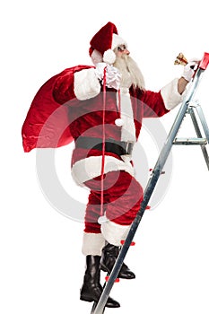 Side view of old saint nick climbing up the ladder