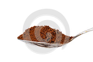 Side view of organic instant coffee powder in metal teaspoon