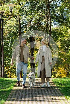 Side view of overjoyed couple walking