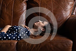 Side view peaceful attractive woman lying resting on cozy couch