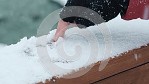 Side view of people writing on the snow with finger glove drawing a heart for love message concept. Winter season holiday vacation
