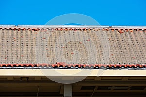 Side view of a pitched roof with removed clay roof tiles