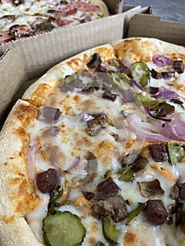 Side view of pizza with salami and cheese on the table