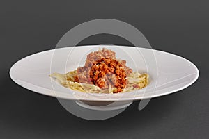 Side view of plate with spaghetti with fried ground-meat