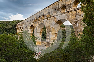 Side view of the Pont du Gard, an ancient Roman aqueduct bridge through Gardon River in Provence, southern France.