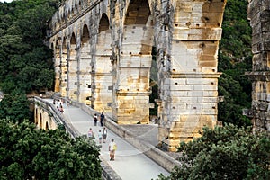 Side view of the Pont du Gard, an ancient Roman aqueduct bridge over Gardon River in southern France.