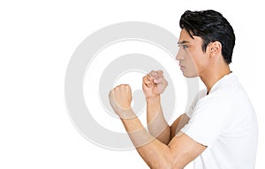 side view portrait of an angry upset young man, worker with fists in air isolated on white background