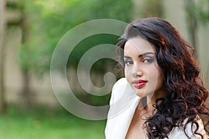 Side view portrait of attractive young asian brunette woman looking at camera smiling with confident lifestyle concept.