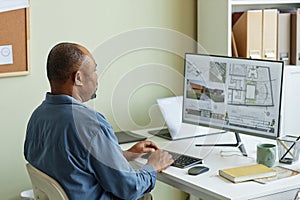 Black man as architect using computer
