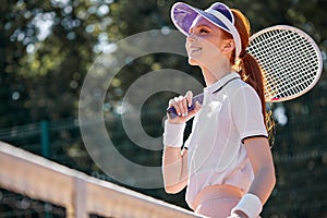 Side View Portrait Of Cheerful Female In Tennis Female Uniform Standing By Net