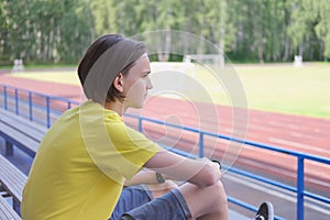 Side view portrait of a pensive thoughtful teen boy