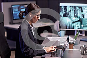 Side view portrait of serious businesswoman using laptop