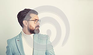 Side view portrait of serious fashionable handsome man in blue suit.