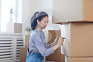 Young Asian Woman Packing Boxes
