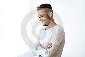 Side view portrait of smiling handsome man on white background