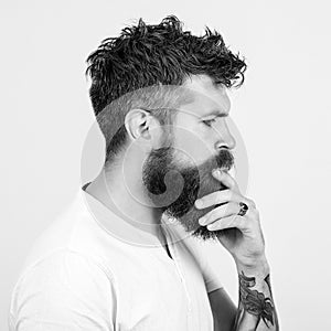 Side view portrait of thinking brutal bearded guy looking away. Creative handsome man thinking on productive ideas for developing