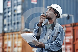 Side view portrait of young black man using walkie talkie