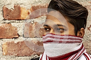 Side View Portrait Of A Young Male Model With Scarf Covered Face.