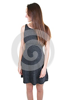 Side view of pretty slim woman in grey dress with long brown hair