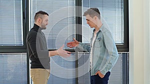 Side view of professional manager shake hand of man client or customer making business deal at office meeting on