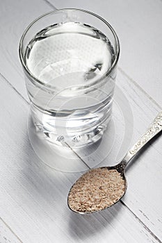 Side view of psyllium husk in iron spoon isolated