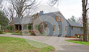 Side View of Ranch Style Cobblestone and Gray Home photo