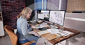 Side View Of Real Estate Designer Working On Computer