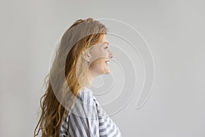 Side view of red-head pretty woman, studio shot