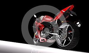 Side view of red sports motorcycle in a spotlight