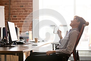 Side view relaxed businesswoman resting leaning on comfortable office chair photo