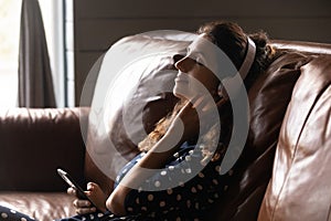 Side view relaxed woman in headphones listening to music