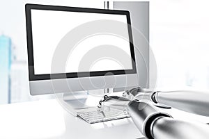 Side view of robot hands typing, computer screen