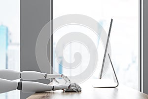 Side view of robot using computer