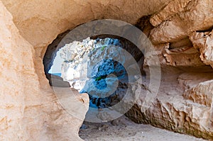 Side view on the round entrance tunnel to unique sea cave in massive rock in Tropea city near the famous Rotonda beach. Tyrrhenian