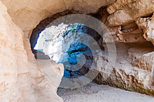 Side view on the round entrance tunnel to unique sea cave in massive rock in Tropea city near the famous Rotonda beach. Tyrrhenian