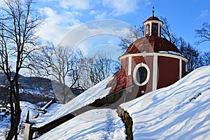 Side view on round rear part of middle church of baroque calvary in Banska Stiavnica, Slovakia, during winter season 2018