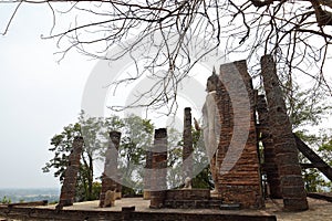 Side view of the ruins of the assembly hall viharn of Wat Saphan Hin and its large standing Buddha image, Sukhothai Historical