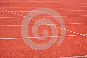 Side view of running track with white line racetrack outdoor stadium. red texture