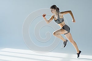 Side view of running woman in sportive clothing