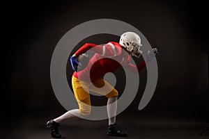 Side view of running woman in white helmet with rugby ball in her hand in studio